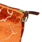 detail orange crackle velvet clutch with brown leather d-ring holders