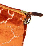 detail orange crackle velvet clutch with brown leather d-ring holders