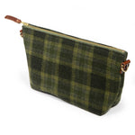 Everyday Wool Clutch in Moss Check, side angle showing the leather zipper pull and leather-tabbed D-ring
