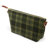 Everyday Wool Clutch in Moss Check, side angle showing the leather zipper pull and leather-tabbed D-ring