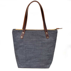 Indigo blue portfolio tote made from Japanese denim with brown leather straps