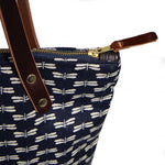 Detail Japanese navy canvas portfolio tote with dragonfly print and brown leather handles and zipper