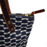 Detail Japanese navy canvas portfolio tote with dragonfly print and brown leather handles and zipper