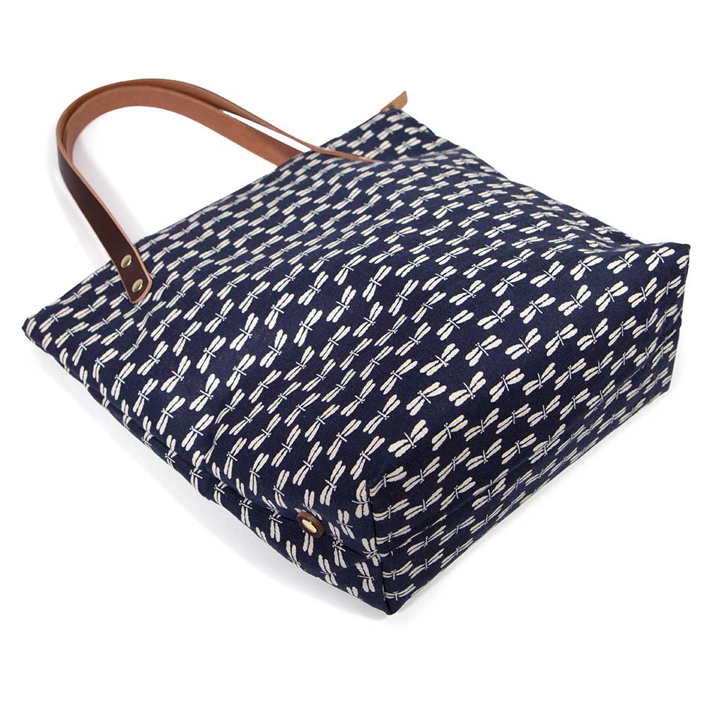 Japanese navy canvas portfolio tote with dragonfly print and brown leather handles and zipper