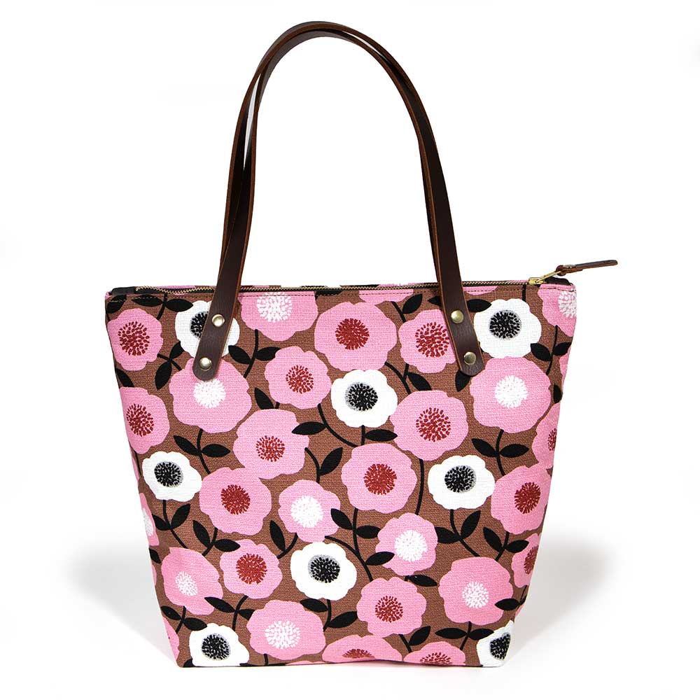 Soft pink floral tote with vintage midcentury-inspired print and brown leather handles
