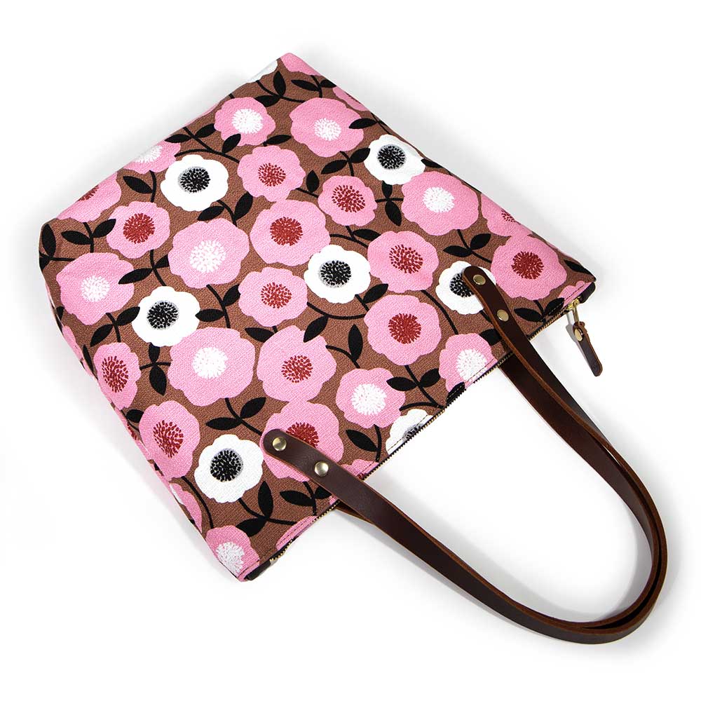 Soft pink floral tote with vintage midcentury-inspired print and brown leather handles