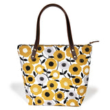 Golden yellow midcentury-style floral canvas tote with brown leather straps