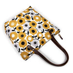 Golden yellow midcentury-style floral canvas tote with brown leather straps
