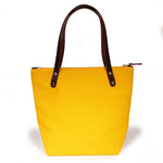 Yellow waxed canvas portfolio tote with brown leather handles
