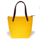 Yellow waxed canvas portfolio tote with brown leather handles