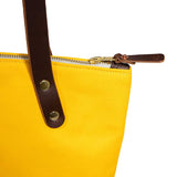 Detail Yellow waxed canvas portfolio tote with brown leather handles