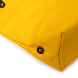 Detail Yellow waxed canvas portfolio tote with brown leather handles