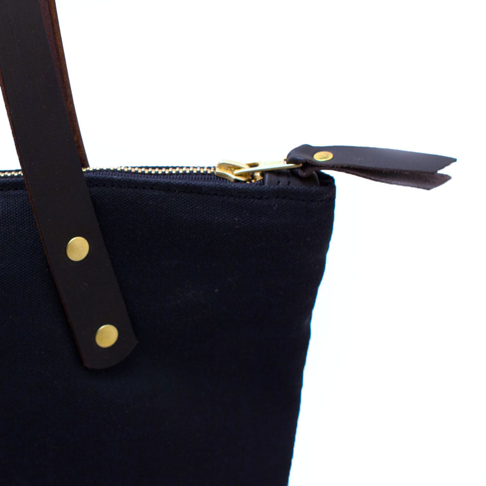 Detail Navy waxed canvas portfolio tote with brown leather handles and zipper