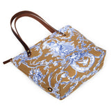 Portfolio tote featuring oak and ink blue toile print with brown leather handles and zipper