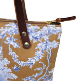 Detail Portfolio tote featuring oak and ink blue toile print with brown leather handles and zipper
