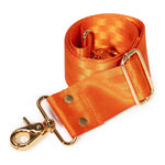 An orange satin strap with gold-tone hardware, including a lobster clasp, metal rings, and a rectangular buckle, shown on a plain white background.