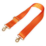 An orange satin strap with gold-tone metal hardware, including a buckle, adjustment loops, and two lobster clasp connectors, shown on a plain white background.