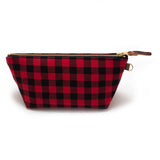Front of the Buffalo Check Travel Clutch, red and black buffalo check, with brass zipper and mahogany leather pull