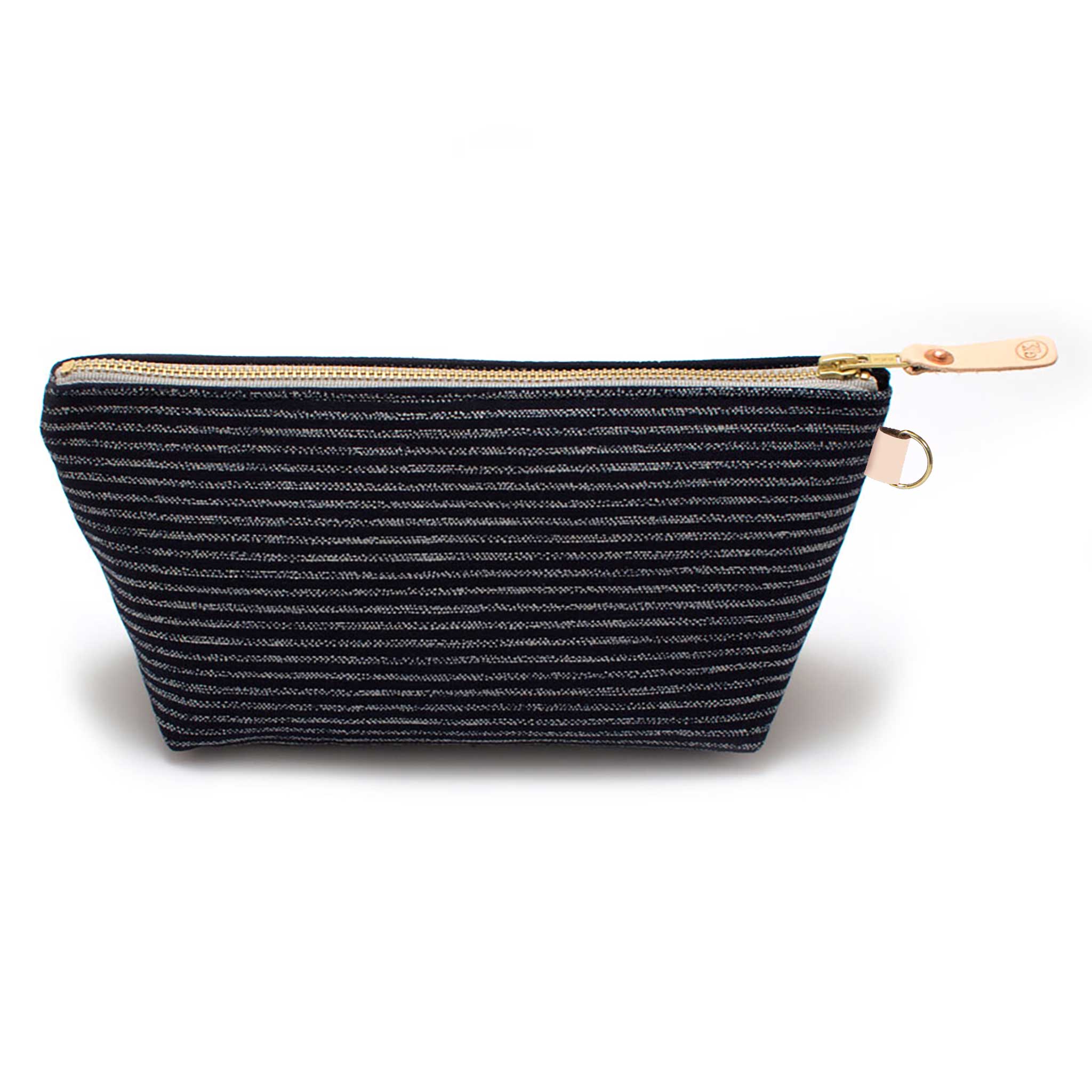Front of the Indigo Chalk Stripe Travel Clutch, white chalk stripes on indigo, with brass zipper and blonde leather pull