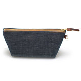 Front of the Japanese Denim Travel Clutch, indigo denim, with brass zipper and mahogany leather pull