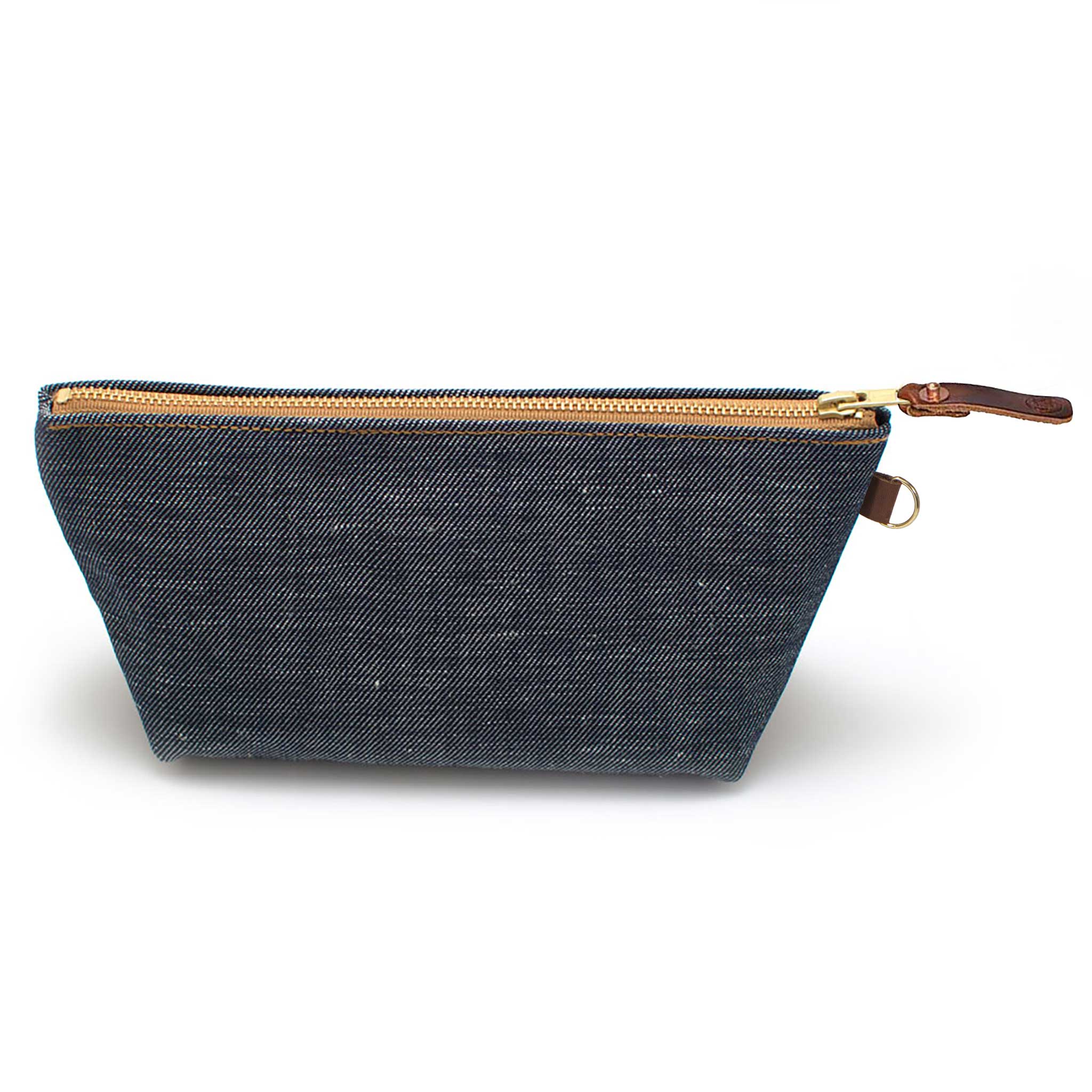 Front of the Japanese Denim Travel Clutch, indigo denim, with brass zipper and mahogany leather pull