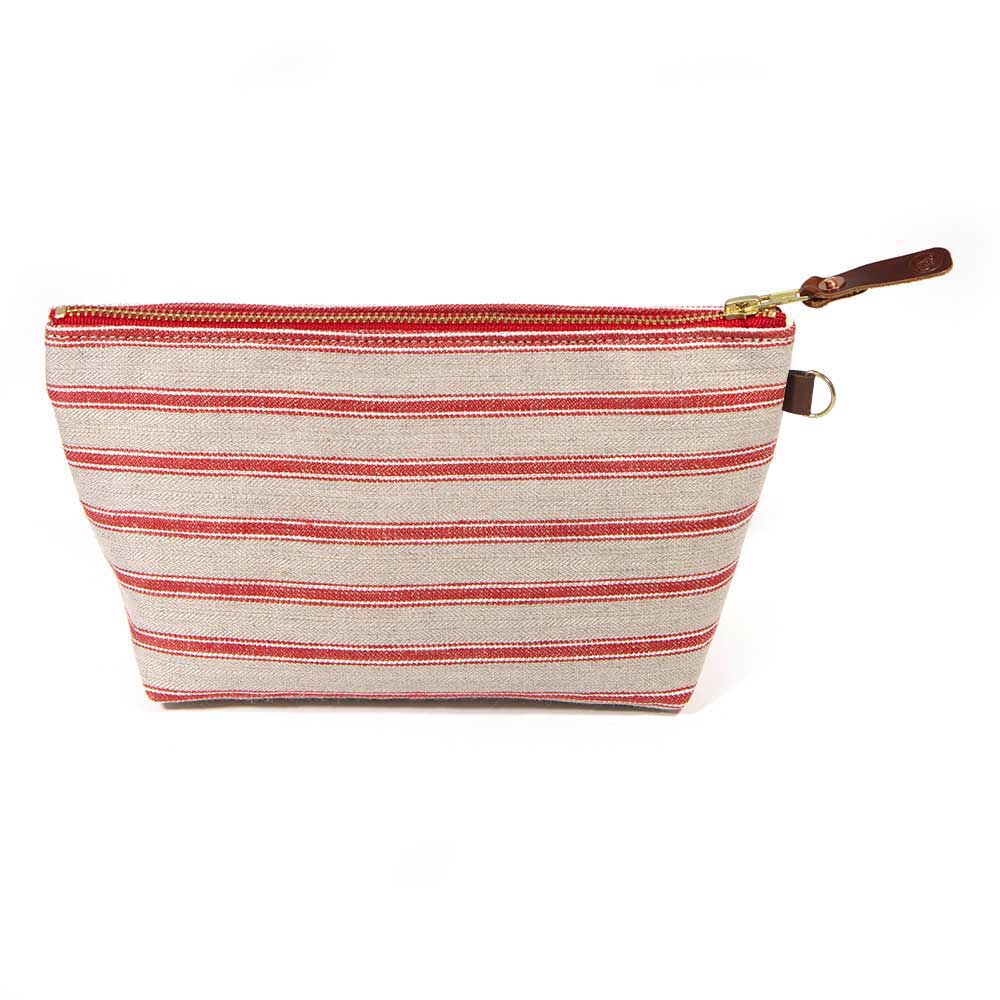 Front of the Sailor Stripe Linen Travel Clutch, red stripes on flax linen, with brass zipper and mahogany leather pull
