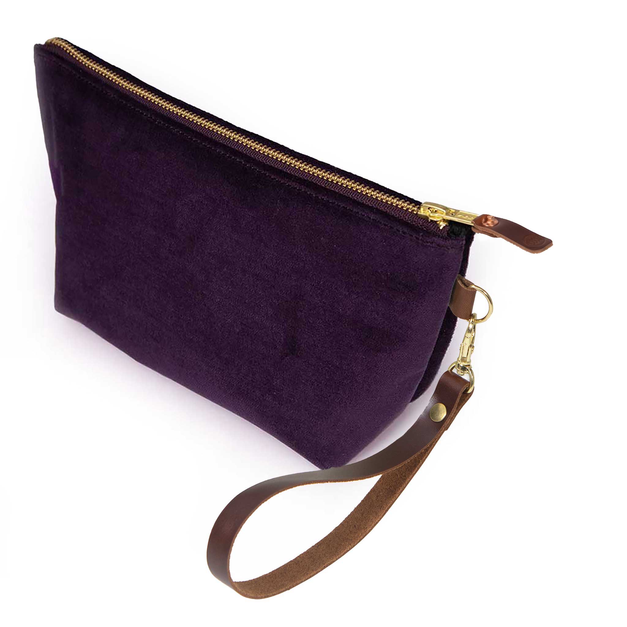 The Royal Purple Velvet Travel Clutch, royal purple velvet, shown with its detachable mahogany leather wristlet clipped to a brass D-ring
