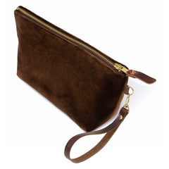 The Walnut Velvet Travel Clutch, walnut brown velvet, shown with its detachable mahogany leather wristlet clipped to a brass D-ring