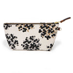 Front of the Dots & Blooms Travel Clutch, black dots and blooms on cream, with brass zipper and mahogany leather pull
