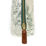 Close-up of the brass zipper and leather General Knot logo pull on the Butter and Pine Toile Travel Clutch