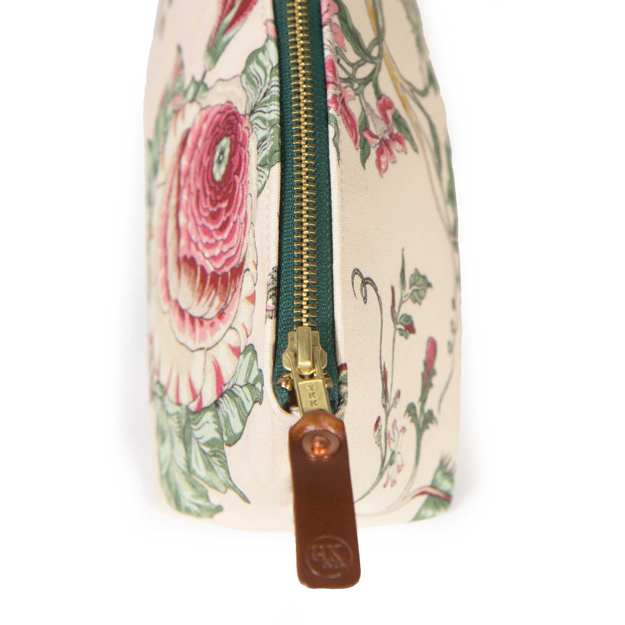 Close-up of the brass zipper and leather General Knot logo pull on the Botanique Floral Print Travel Clutch