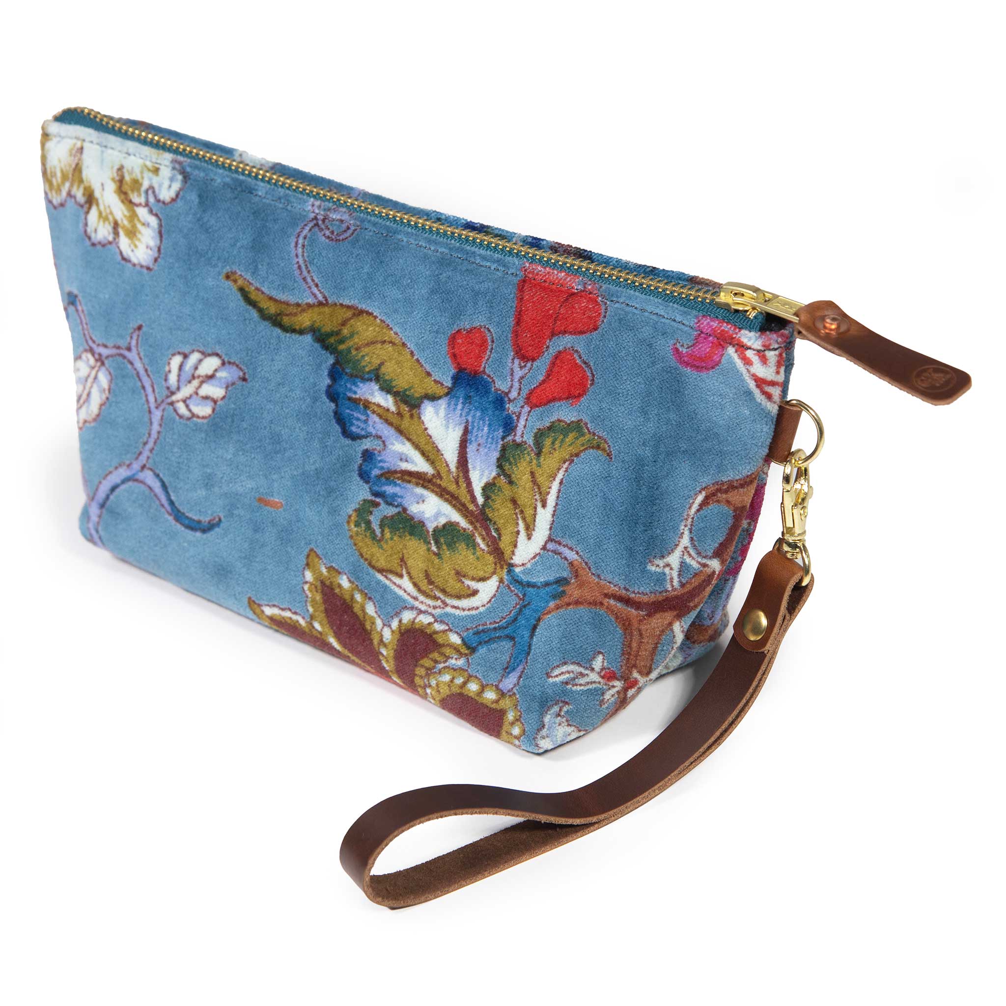 Palampore velvet travel clutch in duck egg blue with a tree-of-life floral, shown with its detachable mahogany leather wristlet