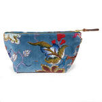 Front of the Palampore velvet travel clutch: scarlet, olive and indigo blooms on duck egg blue velvet with a brass zipper