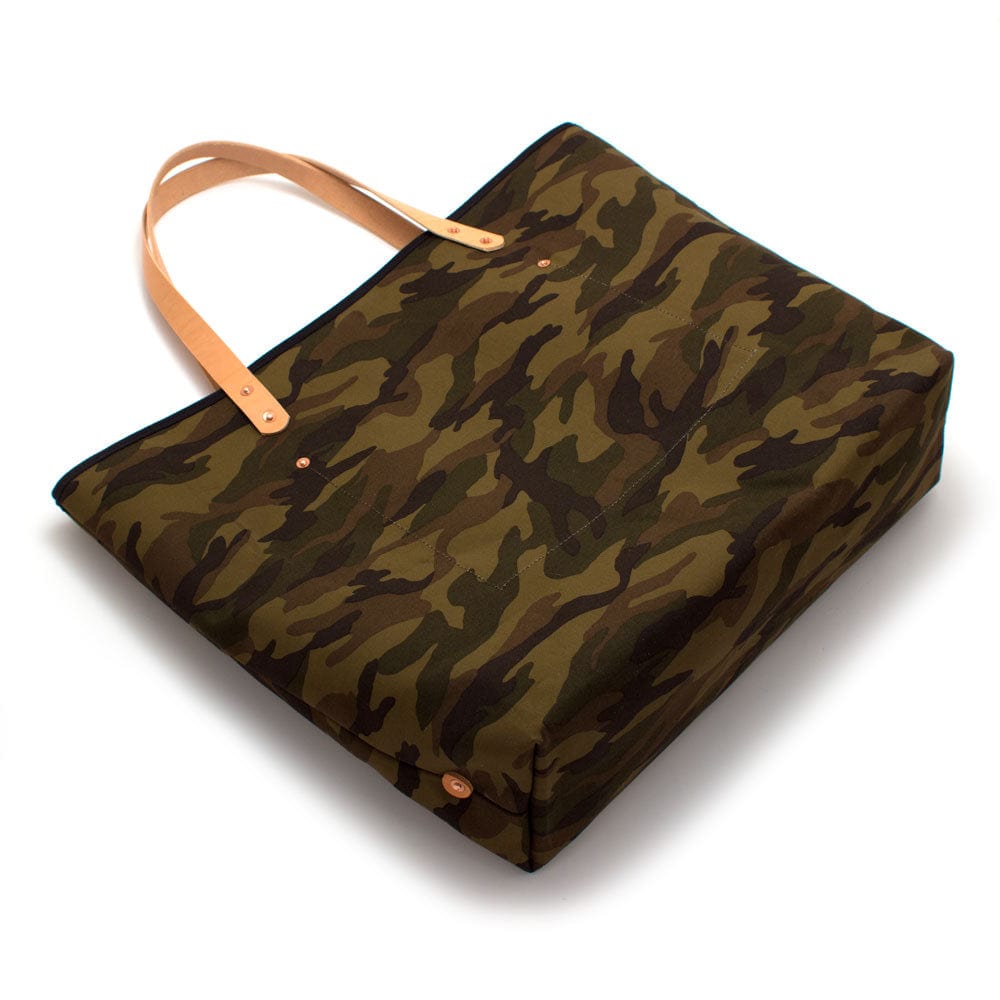 Classic camouflage print canvas tote with blonde leather handles and outdoor styling