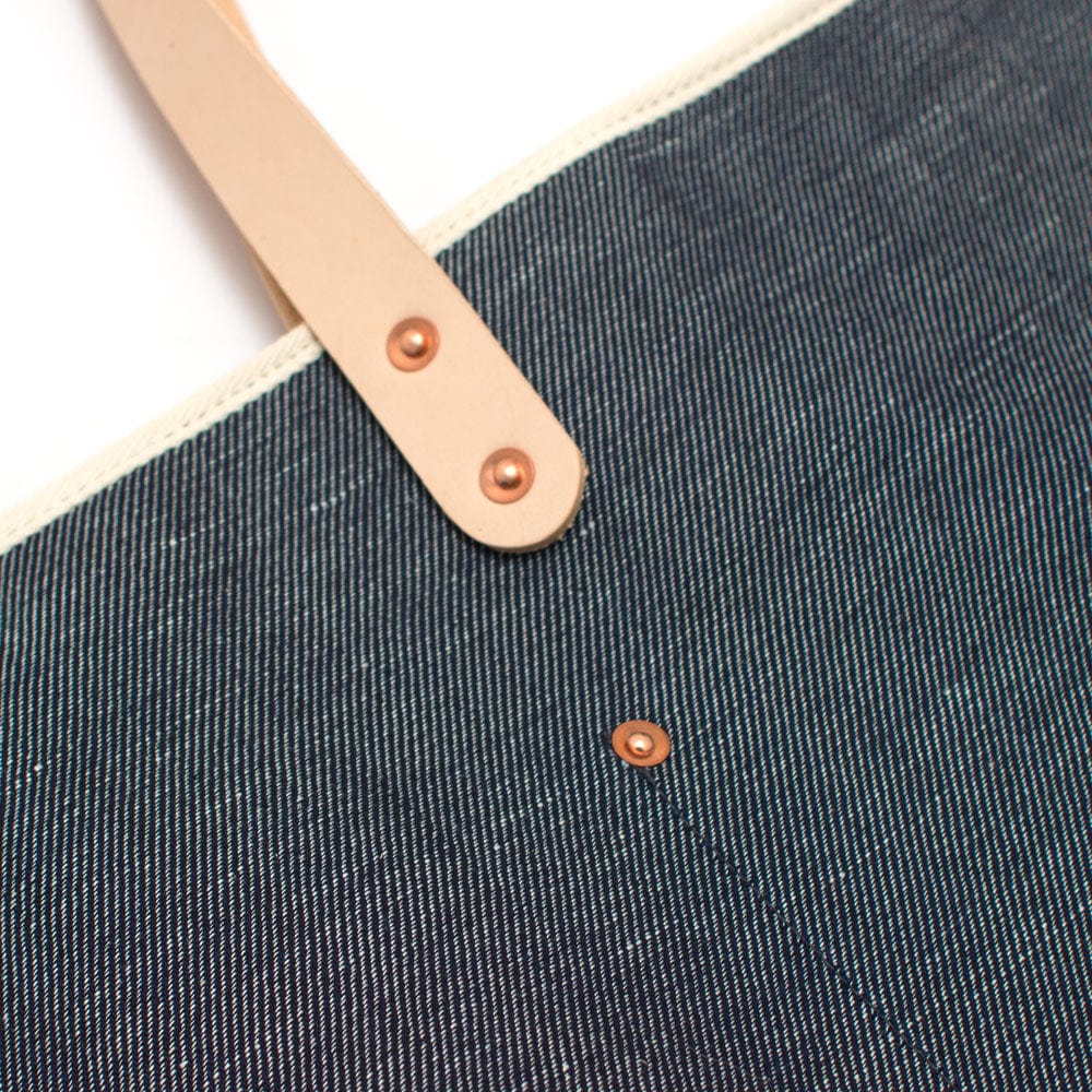 Indigo blue tote made from Japanese denim with blonde leather straps