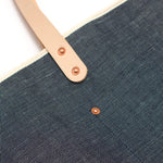 Indigo blue tote made from Japanese denim with blonde leather straps