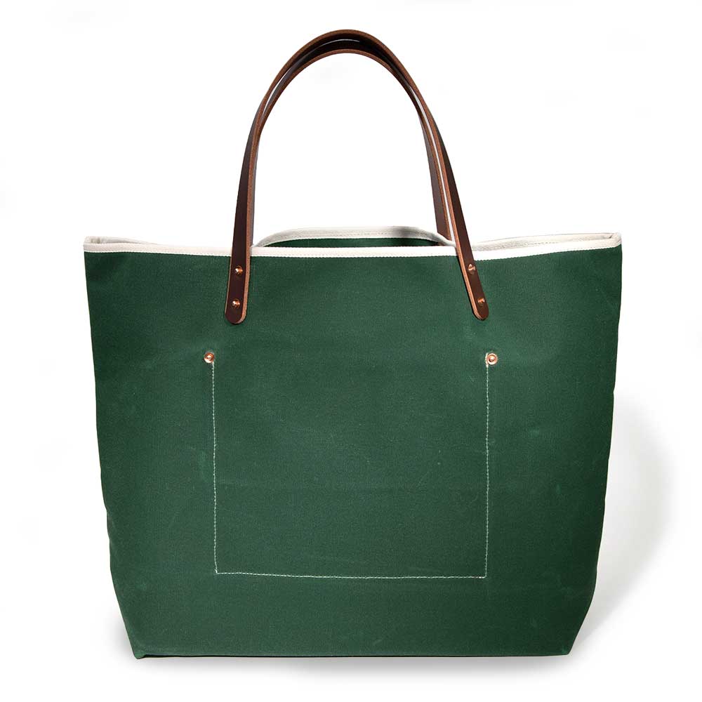 Dark green waxed canvas tote bag with contrast stitching and brown leather handles