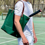Lifestyle Dark green waxed canvas tote bag with contrast stitching and brown leather handles