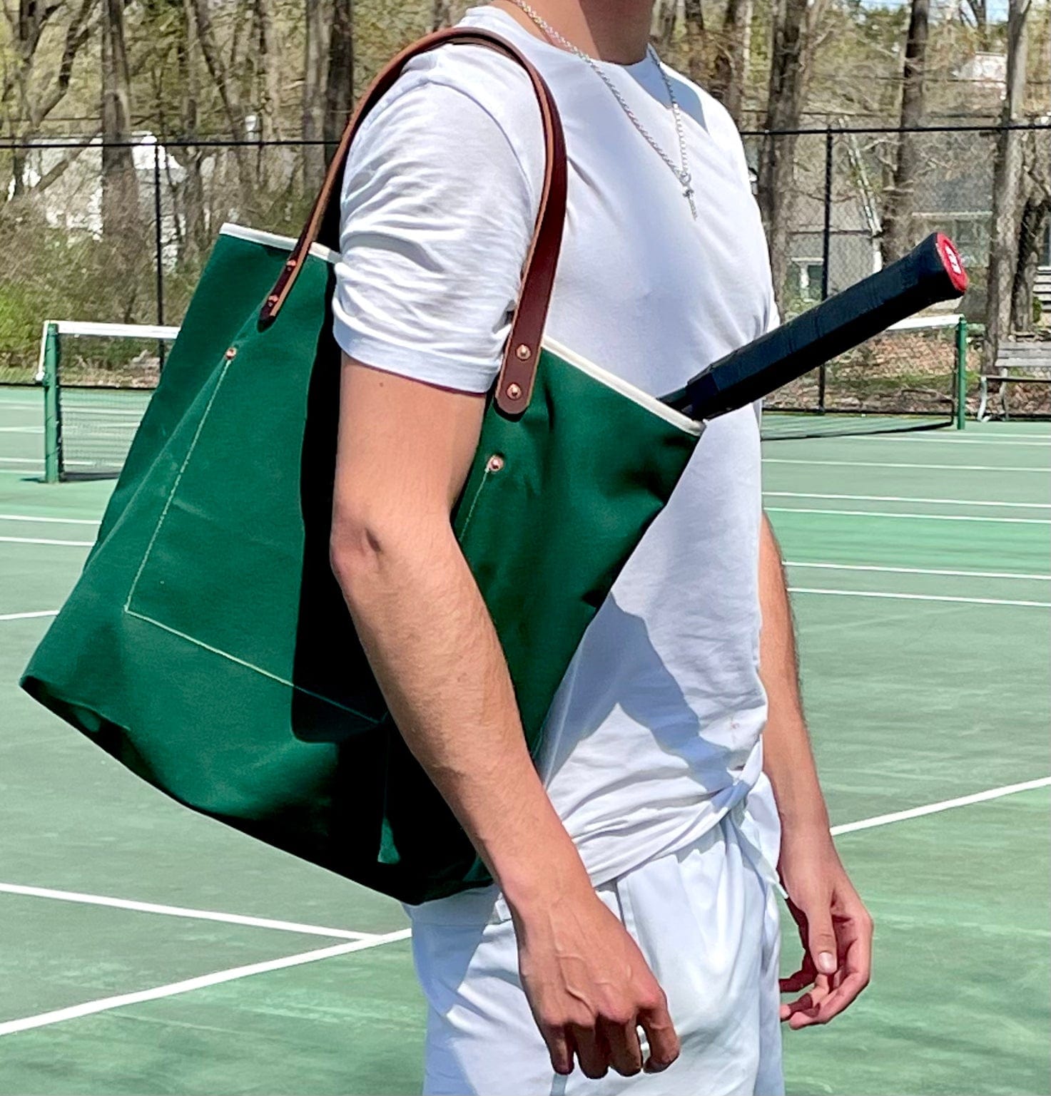 Lifestyle Dark green waxed canvas tote bag with contrast stitching and brown leather handles